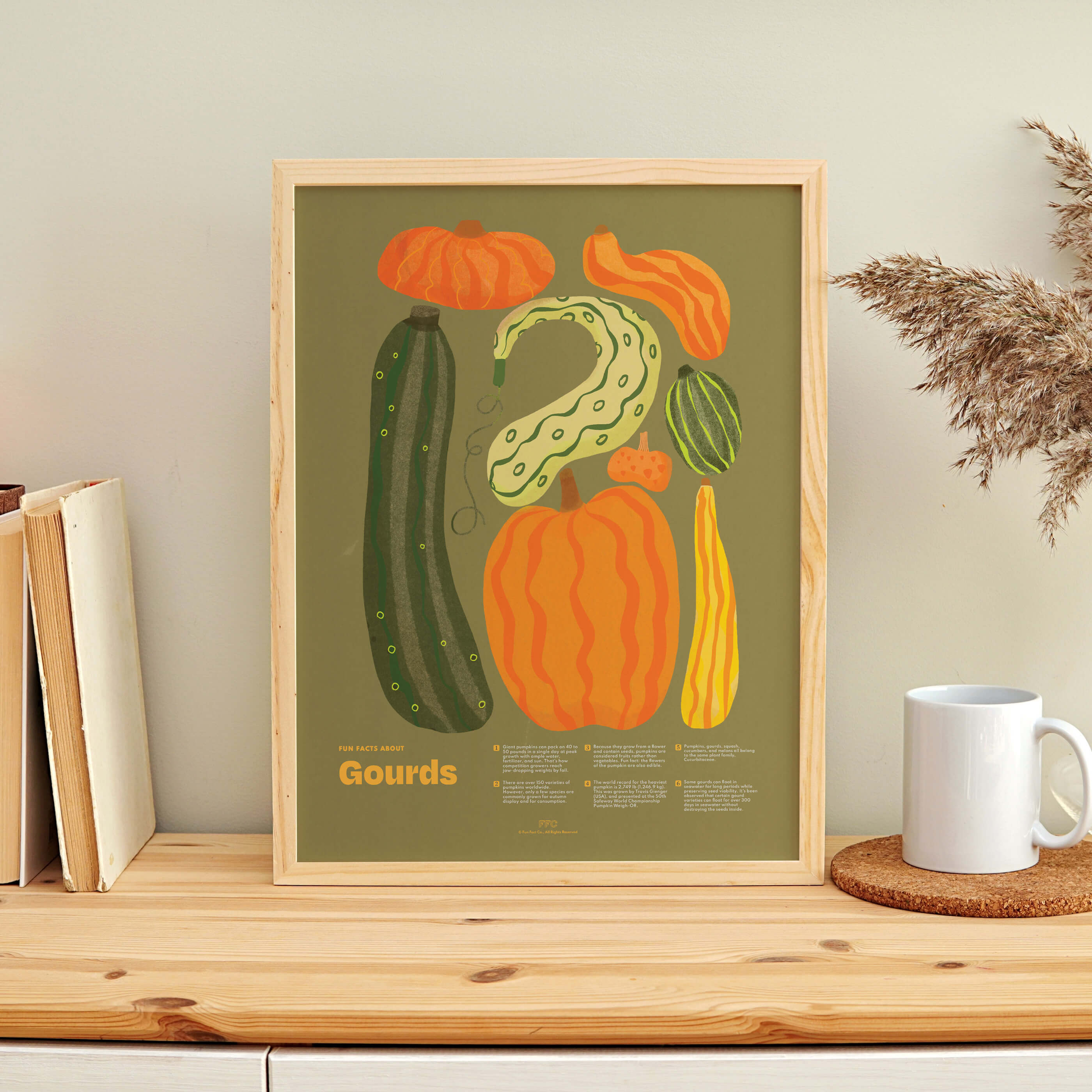 Framed artwork of gourds on a wooden shelf with books and a mug.